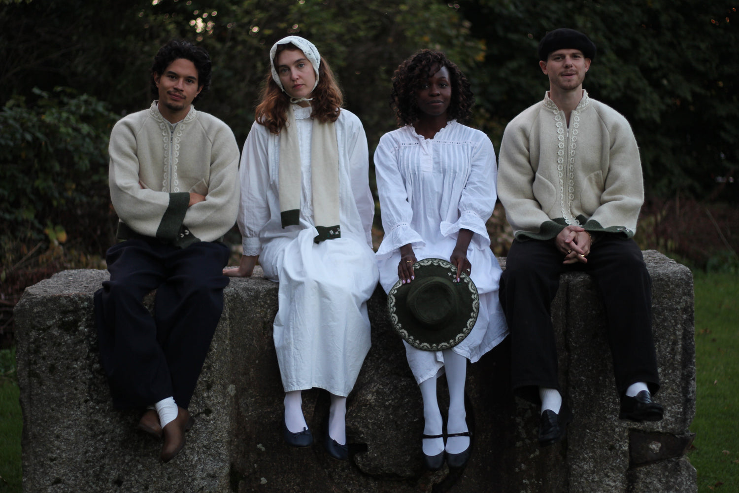 4 Models wearing An Ode to Cotton garments: The unisex beige wool jacket, the unisex beige wool scarf and the unisex green gardening hat