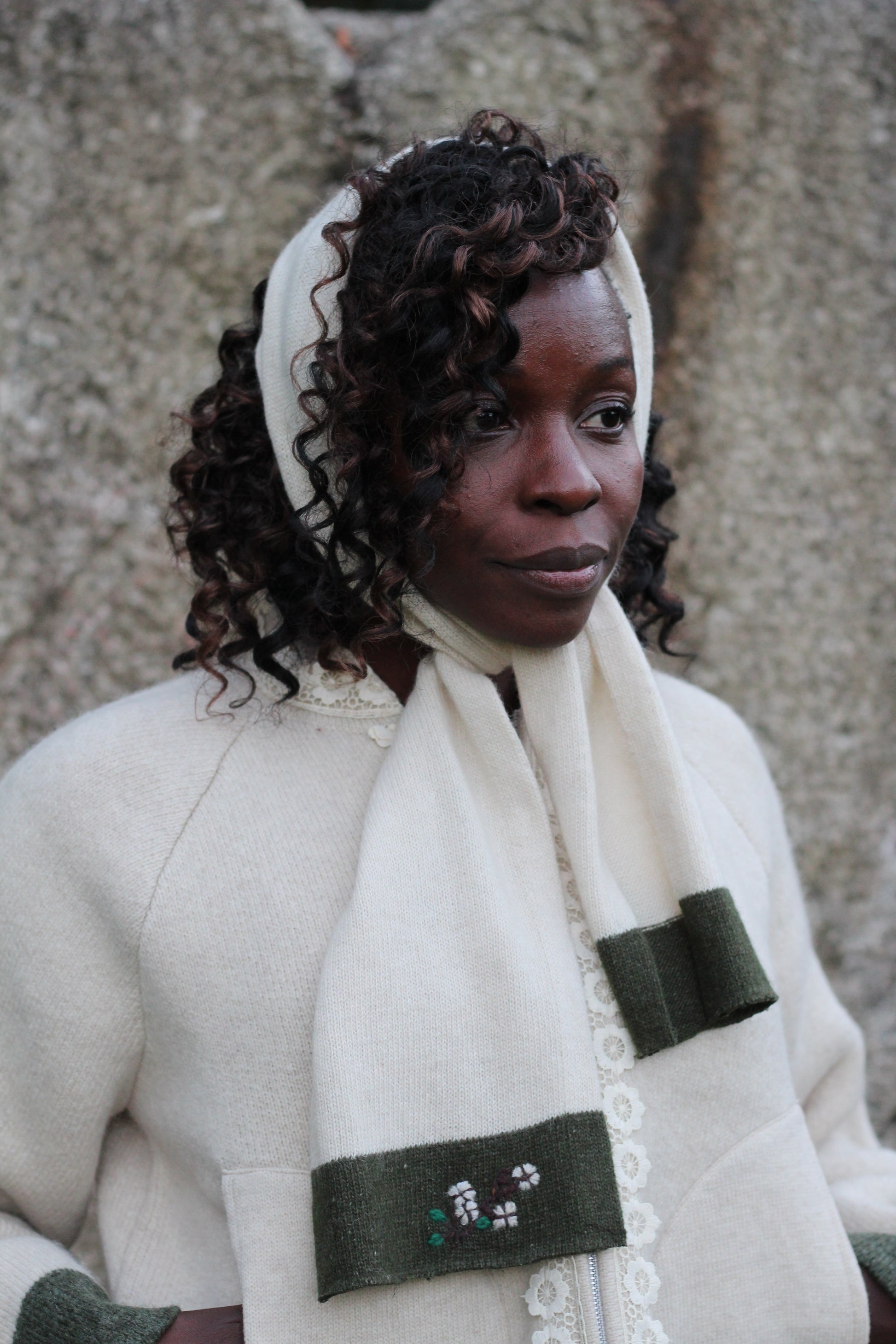 Unisex beige wool scarf worn as headscarf with Unisex beige wool jacket, close up picture